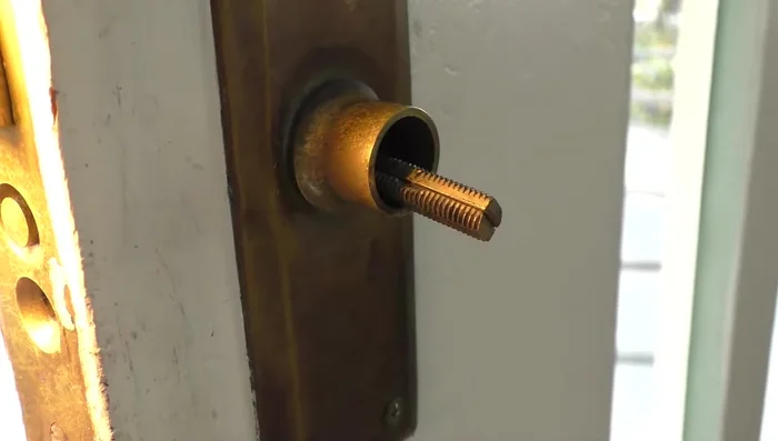 Remove the threaded rods holding the handle in place.