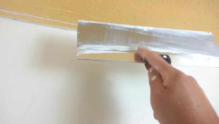 Use a drywall knife (6-inch or 12-inch) to spread the compound evenly, applying pressure on one side and feathering it out. Aim for a smooth surface, but don't worry about minor imperfections on the first coat.