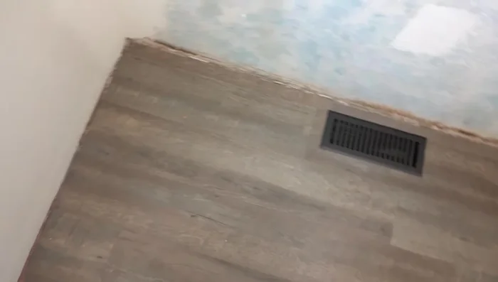 Prepare the area by laying down drop cloths or paper to protect the floor.