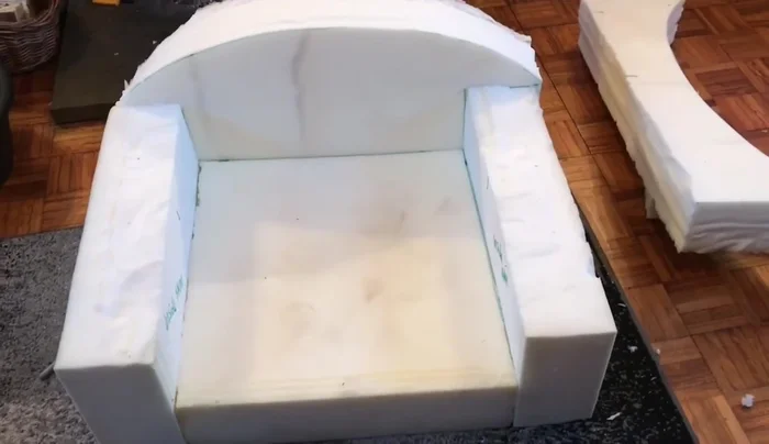 Sew the fabric cover together, ensuring it fits snugly around the foam base.