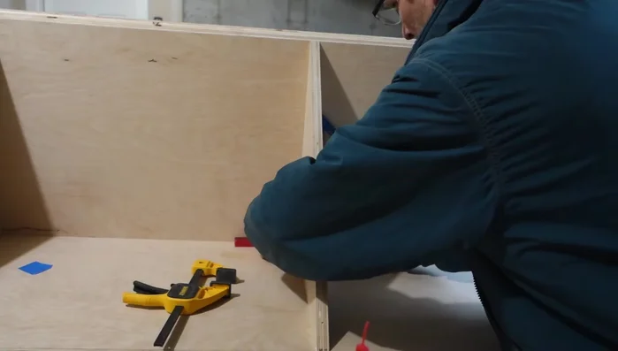 Attach the lower faceboard flush against the edge of each side panel, lower shelf, and floor.