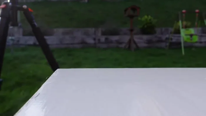 Secure a straight edge along the cutting line using clamps.