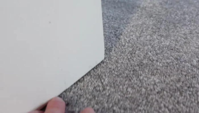 Identify and mark the tight points on the door where it rubs against the floor.