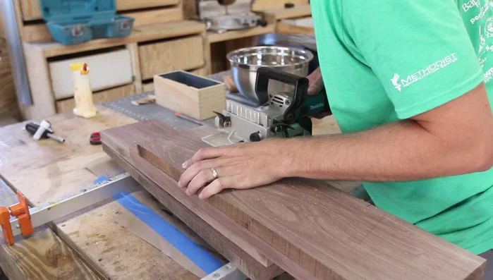 Glue and assemble the walnut panel: Create biscuit slots for alignment, apply glue, insert biscuits, and clamp the panel together. Clean up excess glue immediately.