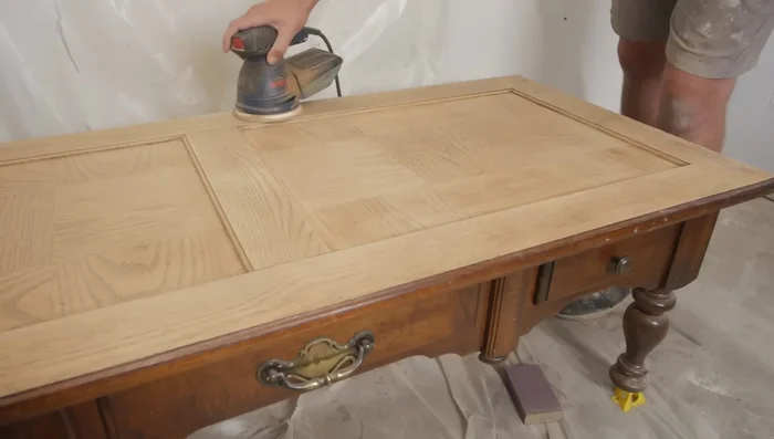 Do a light sanding with 220 grit sandpaper all around the table top.