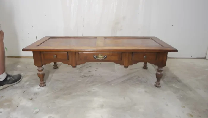 Do a light sanding with 220 grit sandpaper all around the table top.