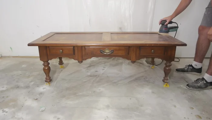 Do a light sanding with 220 grit sandpaper all around the table top.