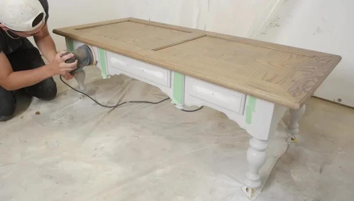 Sand down the front face of the drawers, then apply stain.