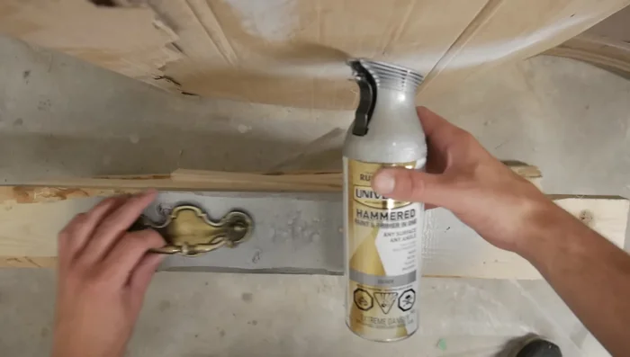 Sand down the existing hardware and apply hammered silver gray paint.