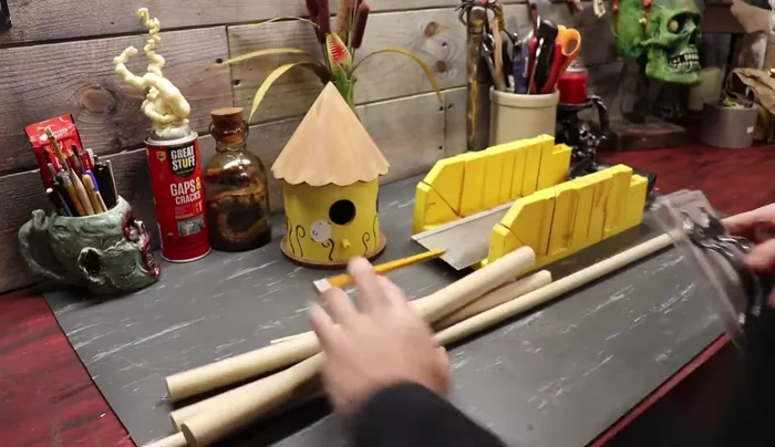 Prepare materials: Gather leftover doll pieces, a spigot, a drawer pull or gate latch, dowels, and other small parts.