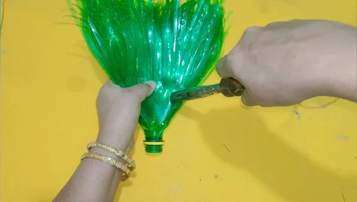 Secure the bristles: Make three holes near the top of the main bottle. Use string, fabric, or a net to secure the bristles and prevent them from falling out. Reinforce with bangles or screws.