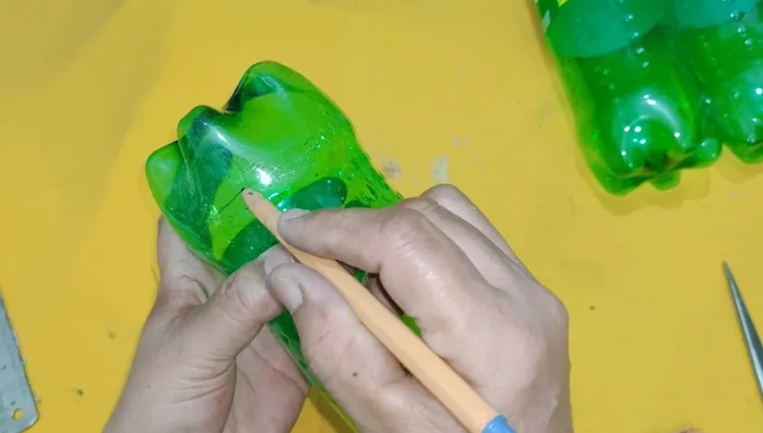Prepare the bottles: Remove the rims from the plastic bottles. Mark the bottom line of each bottle and cut along the line to create a flat base.