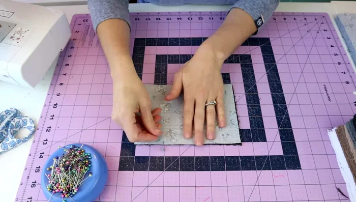 Pin the fabrics: Pin the layers together along all sides, ensuring even alignment.