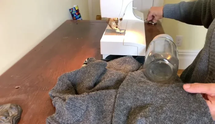 Measure and cut a piece of sweater fabric slightly longer than your mason jar.