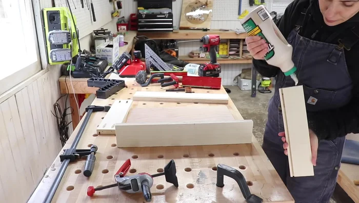 Install the drawers into the compartments, pre-drilling holes for the slides.