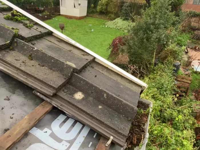 Replace the roof tiles, ensuring proper alignment and cleaning joints as you go. Use construction-grade foam and clips to secure the tiles.