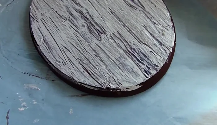 Repeat distressing: Repeat the distressing process on the sides of the plaque.