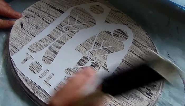 Remove stencil: Once dry, carefully peel off the sticker paper stencil. Touch up any imperfections with a paintbrush.