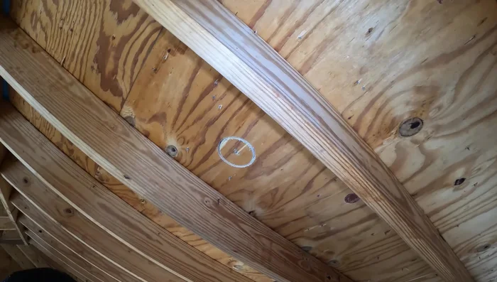 Carefully cut the hole, avoiding damaging the shingles. Cut through the decking only, and then finish cutting the shingles from the top.