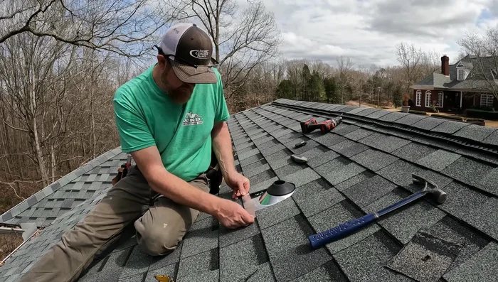 Insert the pipe and flashing into the hole. Secure the flashing with roofing nails.