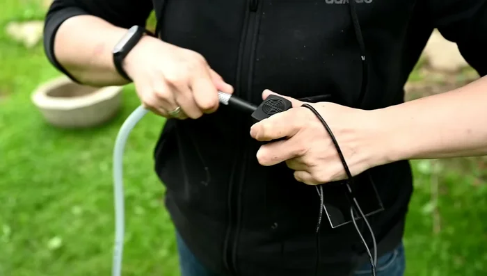 Install the solar pump in the bottom vessel, covering it with landscape fabric to prevent debris.