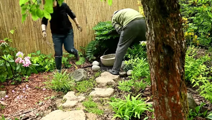 Thread the hose through the bamboo posts and spout.
