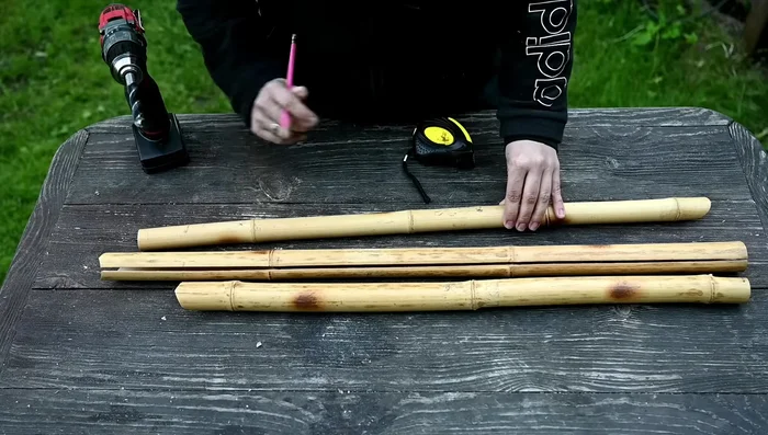 Thread the hose through the bamboo posts and spout.