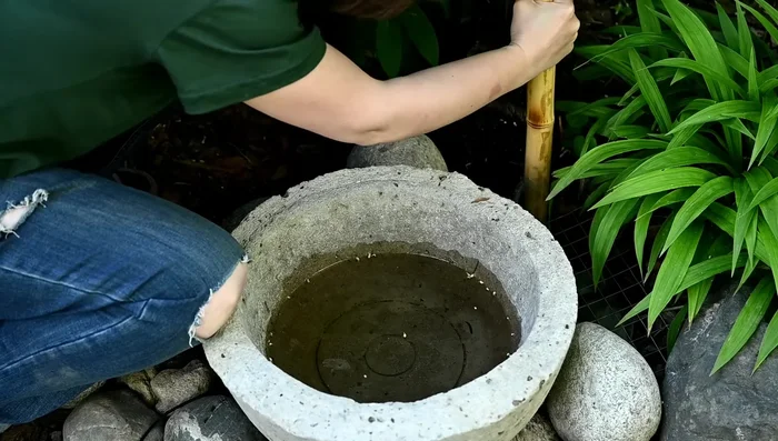 Thread the hose through the bamboo posts and spout.