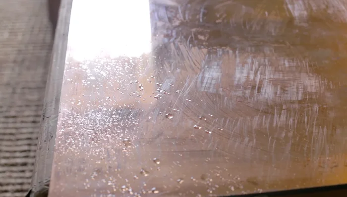 Monitor the progress from the front of the mirror. Dark spots will indicate where the bleach has dissolved the reflective surface. Adjust the application and drying time to achieve desired level of aging.