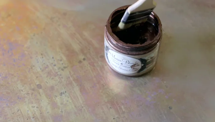 Spray paint the back of the mirror with your chosen color(s). The video suggests dark spray paint, but also uses gold and copper paints for a more realistic effect. Apply in light layers to allow for depth and dimension.