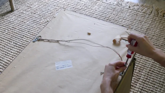 Use a putty knife to carefully remove the gray backing. Be cautious not to scrape the gold layer underneath.