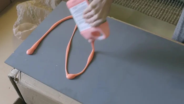 Use a putty knife to carefully remove the gray backing. Be cautious not to scrape the gold layer underneath.