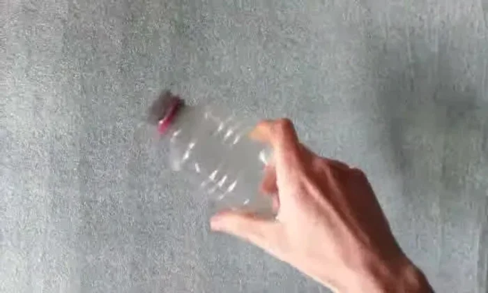 Unscrew the cap from the plastic bottle.