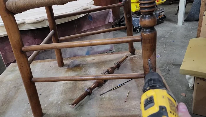 Drill pilot holes into the spindle from the outside of the chair leg to prevent splitting when inserting the screws.