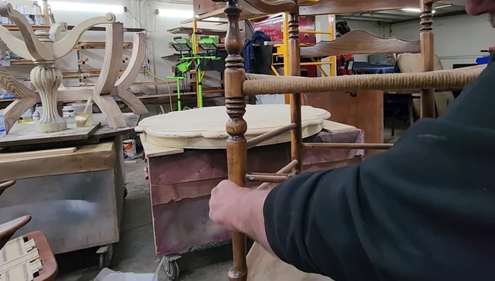 Drill pilot holes into the spindle from the outside of the chair leg to prevent splitting when inserting the screws.