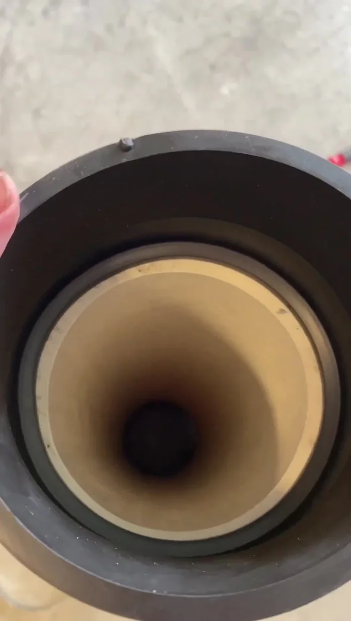 Slide the tapered boots onto the new pipe section. These will connect the thicker 4-inch pipe to the thinner sewer pipe. Mark the position of the boot where it will sit against the existing pipe before sliding it back on for precise cutting.