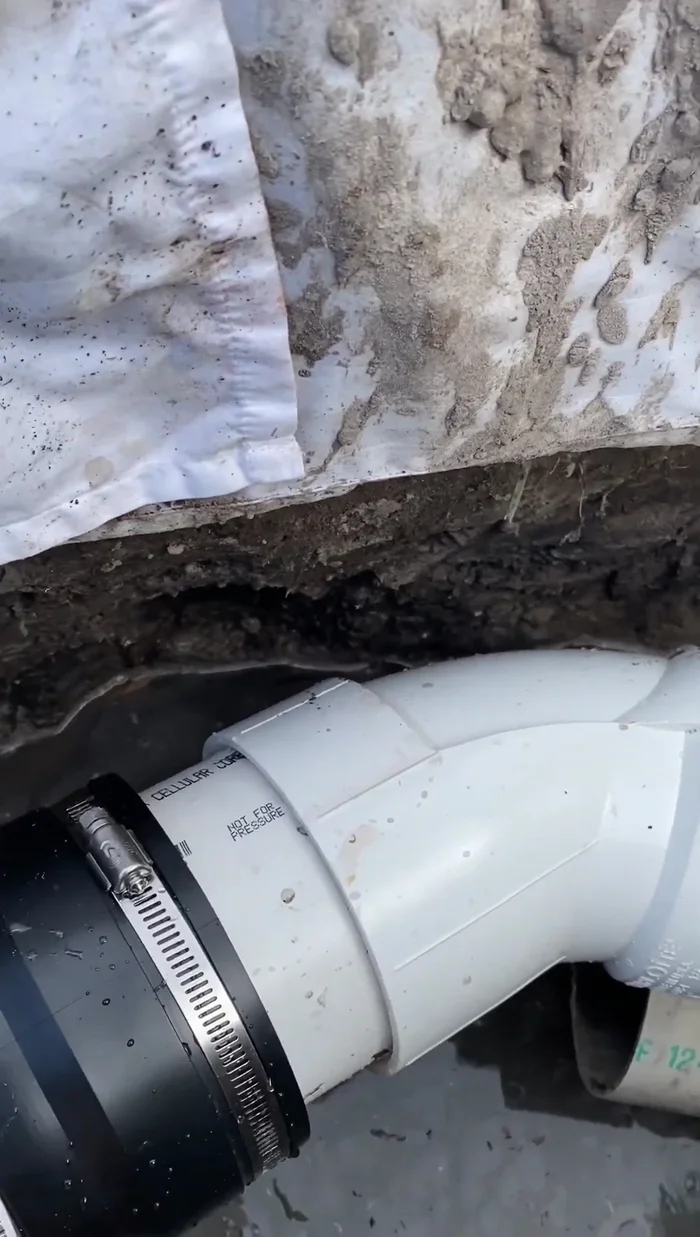 Tighten the hose clamps to secure the connection between the new section and the existing pipe.