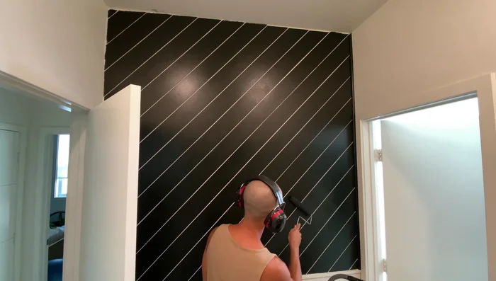 Caulk all edges of the bottom wall for a finished look and replace the towel rack.