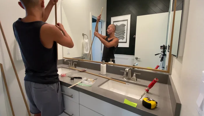 Add x-shaped glass wall vases with pothos plants.