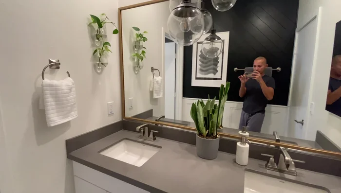 Add x-shaped glass wall vases with pothos plants.