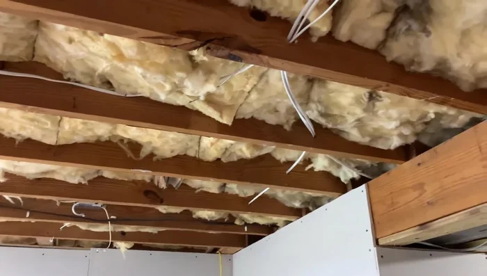 Remove any obstructions (wiring, insulation) from the area where the new joist will be installed.