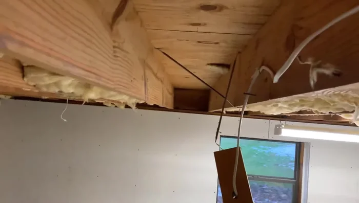 Jack up the sagging joist using a floor jack and 2x4 supports until it's level with a string line.