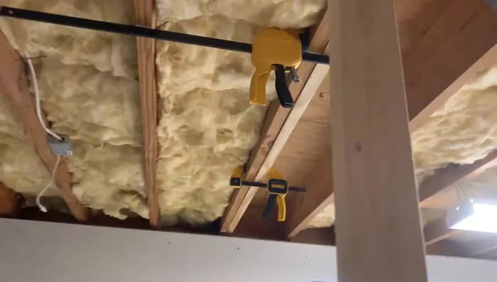 Attach the new joist to the existing joist using construction screws in a staggered pattern.