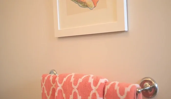 Arrange items on the sink and above the toilet, maintaining a clean and balanced look.