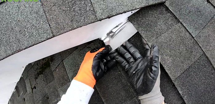 Use a piece of bent flat metal as a wedge to help lift and position the flashing.