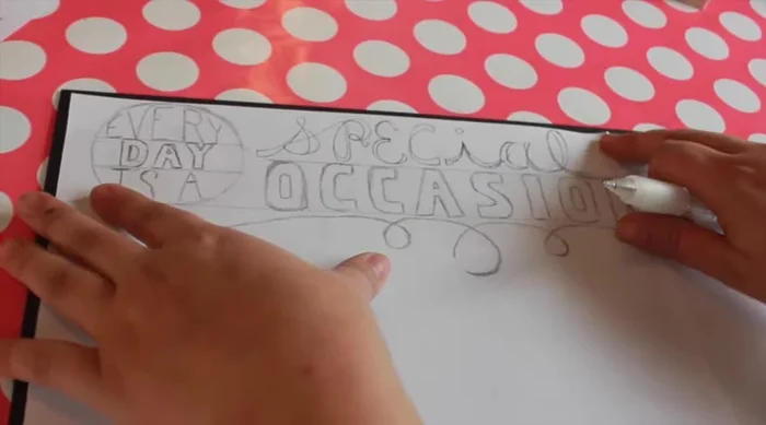 For the menu board (cookie sheet), remove tape from edges, carefully scoring where it meets the paint. Transfer and trace your design, then trace onto the chalkboard with the Sakura Solid Marker Slim.