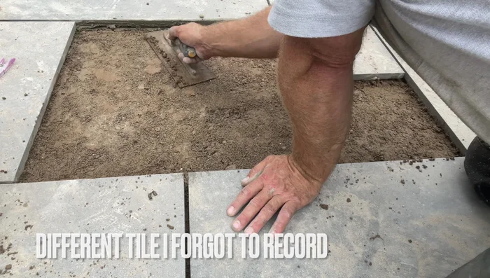 Clean the underside of the tile and the surrounding cement area, removing excess dried cement and debris.