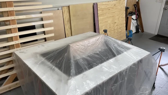 Cover the concrete with plastic to retain moisture during curing.