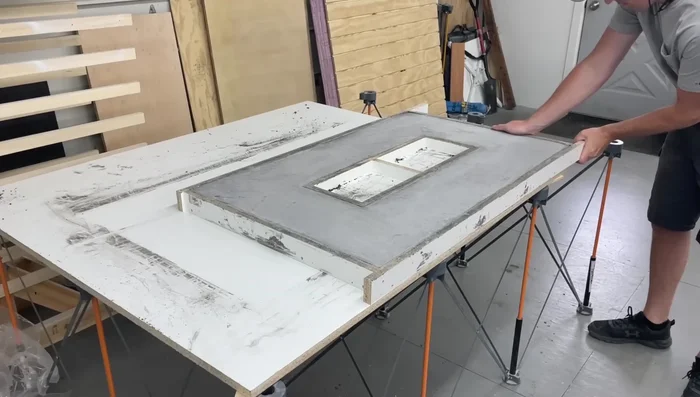 De-mold the concrete top. Fill any imperfections with a concrete slurry and allow to dry. Apply a sealer (wet-look sealer recommended).