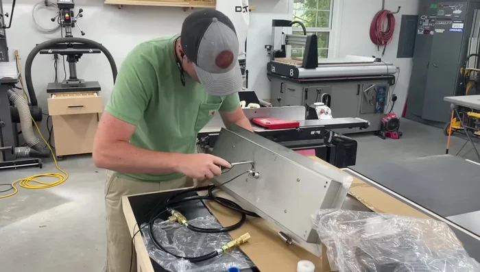 Install the propane fire pit insert and connect the gas line.